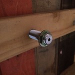 View from the back of the bar, reattaching the hex nut to the beer shank to secure the shank in place.