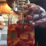 Racking Kombucha Onto Sliced Strawberries