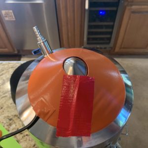 Adhering the MTSs heating pad to the bottom of the Ss Brewtech Brew Bucket Mini