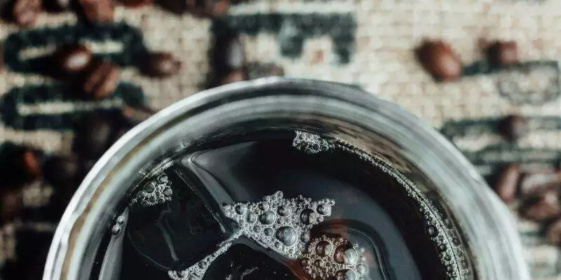 Clear cold brew coffee in a glass jar, filtered through the coffee bed using the vorlauf process